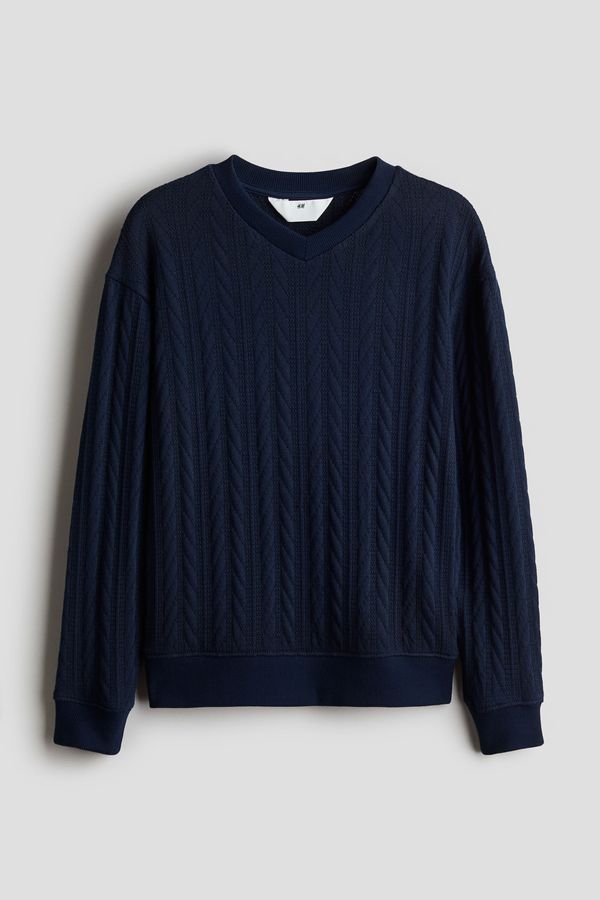Sweater en punto trenzado con cuello en V