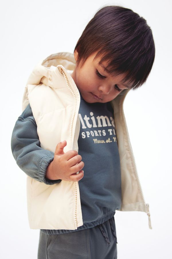 Parka puffy sin mangas con capucha